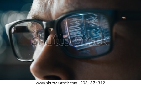Close-up Portrait of Software Engineer Working on Computer, Line of Code Reflecting in Glasses. Developer Working on Innovative e-Commerce Application using Big Data Concept