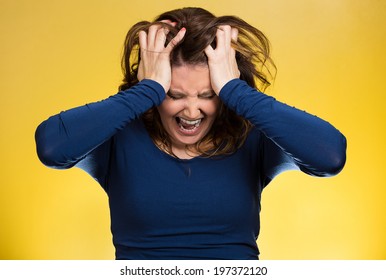 Closeup portrait  stressed business woman, pulling her hair out, yelling, screaming with temper tantrum isolated yellow background. Negative human emotions, facial expressions, reaction attitude