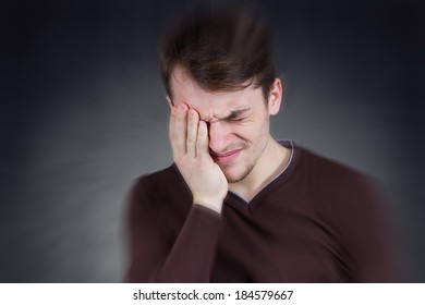 Closeup Portrait, Stressed Man, Overwhelmed Student, Upset Mad Employee Having Headache, Pressured By Lack Of Time, Boss, Project, Family Life, Isolated Smeared Gray Black Background. 