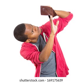 Closeup portrait of stressed, upset, sad, unhappy young man standing with, looking into empty wallet, isolated against white background. Financial difficulties, bad economy concept. Negative emotion
