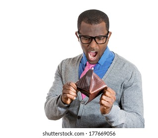 Closeup portrait of stressed, upset, sad, unhappy young shocked man standing with, looking into empty wallet isolated on white background. Financial difficulties, bad economy concept. Negative emotion