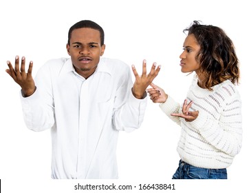 Closeup portrait of stressed young couple going through relationship hard times, isolated on white background. Upset angry sister, wife, girlfriend trying to explain something, man says what did i do?