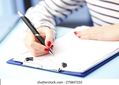 Close-up Portrait Of Student Fill The Test While Sitting At Desk At University. 