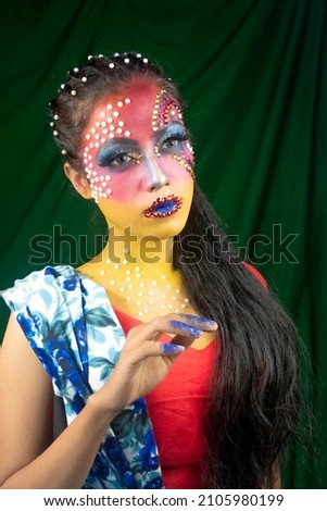 Close-up portrait stylish beautiful young girl with fashionable shiny makeup.