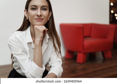 Close-up portrait of successful caucasian young woman sitting in cafe, having business meeting, relax after working all day office, smiling happy looking camera, awaiting for order in restaurant