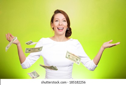 Closeup portrait super excited, laughing young woman who just won lots of money, trying to catch, throw dollar bills in air, isolated green background. Positive emotion, facial expression, feelings