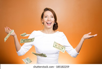 Closeup portrait super excited, laughing young woman who just won lots of money, trying to catch, throw dollar bills in air, isolated orange background. Positive emotion, facial expressions, feelings