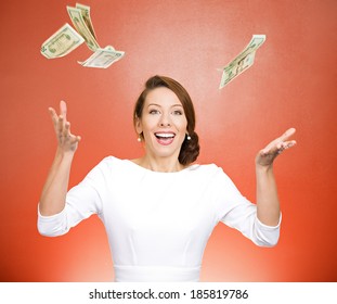Closeup portrait super excited, laughing young woman who just won lots of money, trying to catch, throw dollar bills in air, isolated red background. Positive emotion, facial expression, feelings