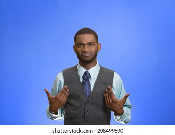Closeup portrait surprised, angry, mad, unhappy, annoyed young executive man, asking question: you talking to, mean me? Isolated blue color background. Negative human emotion, facial expression