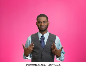 Closeup portrait surprised, angry, mad, unhappy, annoyed young executive man, asking question: you talking to, mean me? Isolated pink color background. Negative human emotion, facial expression