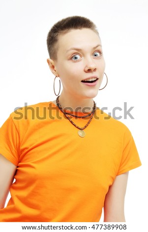 Close-up portrait of surprised beautiful girl open-mouthed. Over white background. Surprised, crazy girl in an orange T-shirt.