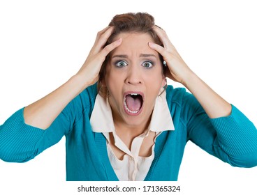 Closeup portrait of a terrified young woman looking shocked surprised in full disbelief hands on head, isolated on a white background. Negative emotion facial expression feelings, body language