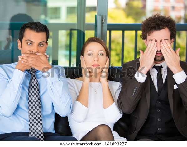 Closeup portrait of three business people\
on black couch imitating see no evil, hear no evil, speak no evil\
concept, isolated on city urban background. Human emotions,\
expressions and\
communication