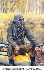 Closeup Portrait Tough Guy Sitting On His Yellow Kayak In The Forest On The River Bank. Outdoor Camping Concept