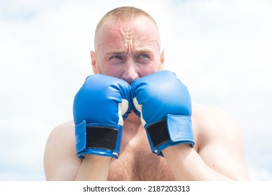 Closeup Portrait Of Tough Male Boxer Posing In Boxing Gloves. Professional Fighter Ready For Boxing Match. Sportsman Muay Thai Boxer Fighting.