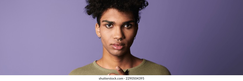 Close-up portrait of transgender african american man with afro hairstyle. Handsome boy looks camera - Powered by Shutterstock