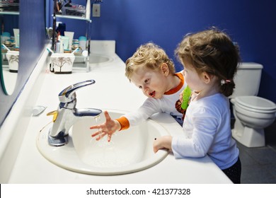 Closeup Portrait Of Twins Kids Toddler Boy Girl In Bathroom Toilet Washing Face Hands Brushing Teeth With Toothbrush Playing With Water, Lifestyle Home Style, Everyday Moments, Morning Routine
