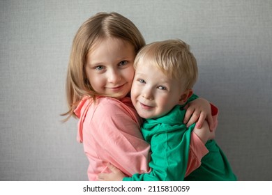 close-up portrait of two children happy and smiling. Blonde brother and sister hugging, sibling relationship concept. funny kids. Boy and girl hugging.