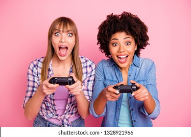 Close-up portrait of two person nice crazy fascinating lovely attractive charming cheerful excited girls in casual checkered shirt playing online having fun isolated over pink pastel background