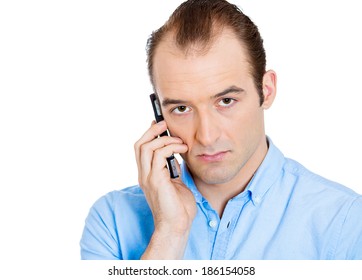 Closeup portrait of upset, sad, depressed, unhappy worried young man talking on cell phone, isolated white background. Negative human emotions, facial expressions, feelings, reaction. Bad news.