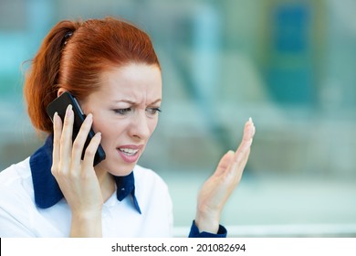 Closeup portrait upset sad, skeptical, unhappy, serious woman talking on phone, walking in hallway isolated office background. Negative human emotion facial expression feeling, life reaction. Bad news