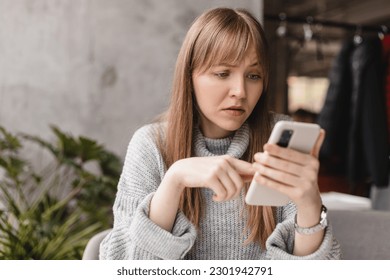 Closeup portrait upset sad skeptical unhappy serious woman talking texting on phone displeased with conversation sitting in cafe. Negative human emotion face expression feeling. - Powered by Shutterstock