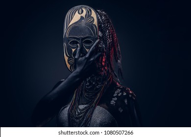 Close-up portrait of a witch from the indigenous African tribe, wearing traditional costume. Make-up concept.