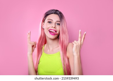 Close-up Portrait Of Woman With Bright Long Colored Pink Hair And Pink Make-up On Studio Background. Professional Coloring