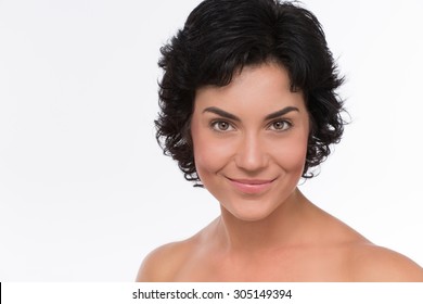 Close-up Portrait Of Woman With Eyes Like Gimlet Isolated On White. Mature Beautiful Adult Brunette Woman With Clean Face. High Key Shot.