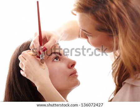 Closeup portrait of a woman having applied makeup by makeup artist