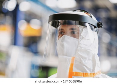 Close-up Portrait Of Worker With Protective Mask And Suit In Industrial Factory.