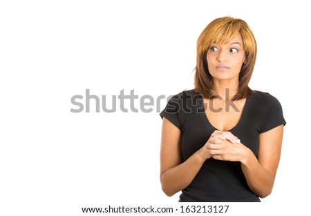Closeup portrait of young adorable young woman worried, playing fiddling with nervous hands looking at space to left, isolated on white background. Negative human emotion facial expression.