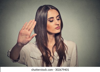 Closeup Portrait Young Annoyed Angry Woman With Bad Attitude Giving Talk To Hand Gesture With Palm Outward Isolated Grey Wall Background. Negative Human Emotion Face Expression Feeling Body Language