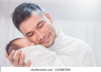 Closeup Portrait Of Young Asian Indian Father Holding His Newborn Baby With Copy Space. Healthcare And Medical Daycare Nursery Love Lifestyle Together Single Dad Father’s Day Holiday Concept