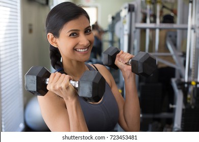 Closeup Portrait, Young Attractive Woman Lifting Weight In Gym, Indoors With Equipment In The Background
