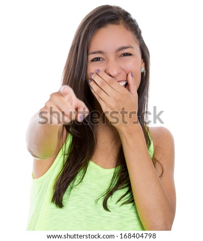 Closeup portrait of young, beautiful, excited, happy woman smiling, laughing, pointing finger towards you, to the camera, covering her mouth isolated on white background. Positive human emotions