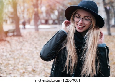 Closeup Portrait Of Young Beautiful Fashionable Woman In Clear Glasses.  Model Wearing Stylish Wide-brimmed Hat, Leather Jacket. Autumn Fall. Female Fashion.Toned