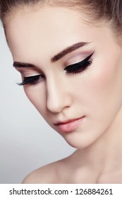 Close-up portrait of young beautiful girl with cat eye make-up