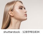 Close-up portrait of young, beautiful and healthy woman with arrows on her face. The spa, surgery, face lifting and skin care concept