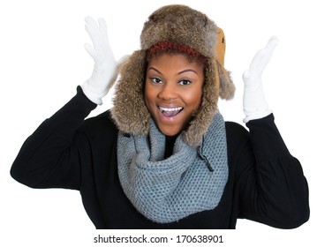 Closeup portrait of young beautiful smiling woman wearing winter gear, gray scarf, white gloves, fur ski cap, and black sweater, isolated on white background. Positive emotion facial expression