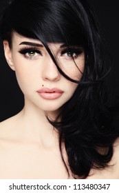 Close-up portrait of young beautiful woman with trendy make-up and hairstyle