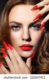 Close-up Portrait Of Young Beautiful Woman With Red Lipstick And Long Stiletto Nails