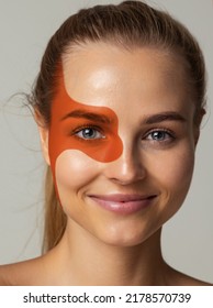 Close-up Portrait Of Young Beautiful Woman With Prange Dye On Face, Eye Isolated Over Grey Studio Background. Body Art, Aesthetics. Concept Of Creativity, Beauty, Fashion, Style, Youth, Artwork