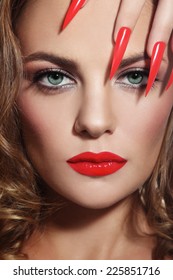 Close-up Portrait Of Young Beautiful Woman With Red Lipstick And Long Stiletto Nails