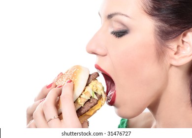 Close-up Portrait Of Young Beautiful Woman Is Eating Big Mac Isolated On White