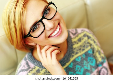 Closeup portrait of a young cheerful woman in glasses 