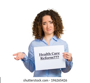 Closeup Portrait Young Confused Skeptical Woman Holding Sign Health Care Reform, Uncertain About Universal Health Care Coverage Isolated White Background. Politics, Government, Legislation Negotiation