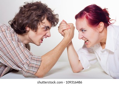 Close-up portrait of a young couple that fights on his hands on a light background