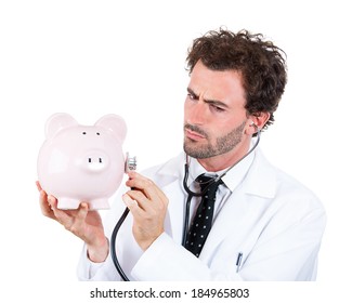 Closeup Portrait, Young Curious Male Man Healthcare Professional, Doctor, Nurse Listening To Piggy Bank With Stethoscope. Medical Insurance, Medicare Reimbursement Concept . Health-law Coverage Gap 