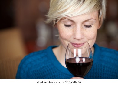 Closeup portrait of young female customer drinking red wine with eyes closed - Powered by Shutterstock